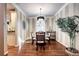 Bright dining room with hardwood floors and stylish light fixture at 10697 W Roxbury Ave, Littleton, CO 80127