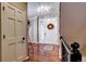 Bright entryway with hardwood floors and a coat closet at 10697 W Roxbury Ave, Littleton, CO 80127