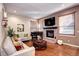 Spacious living room features a fireplace, hardwood floors, and ample natural light at 10697 W Roxbury Ave, Littleton, CO 80127