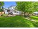 Expansive backyard with mature trees, stone accents, and a well-manicured lawn at 1190 W 11Th Ct, Broomfield, CO 80020