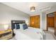 Bright bedroom featuring a large window, a closet, and stylish decor at 1190 W 11Th Ct, Broomfield, CO 80020