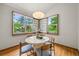 Dining room features a round table, statement light fixture and bright windows overlooking the exterior at 1190 W 11Th Ct, Broomfield, CO 80020