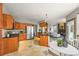 Modern kitchen with wood cabinets, stainless steel appliances, and an island with countertop seating at 1190 W 11Th Ct, Broomfield, CO 80020