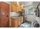 Spacious laundry room features a sink, storage, stacked washer/dryer, and bench seating at 1190 W 11Th Ct, Broomfield, CO 80020