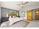 Vaulted main bedroom boasts a ceiling fan, accent wall, and ensuite bathroom and walk-in closet at 1190 W 11Th Ct, Broomfield, CO 80020