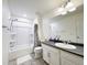 Bathroom with bathtub, shower and vanity with dark countertop at 8951 E 59Th Pl, Denver, CO 80238