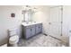 Bathroom boasting a double vanity, tiled floors, and plenty of counter space at 8951 E 59Th Pl, Denver, CO 80238