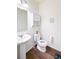 Bathroom featuring a pedestal sink and open toilet seat at 8951 E 59Th Pl, Denver, CO 80238