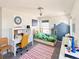 Brightly colored bedroom with bed, desk, and chair at 8951 E 59Th Pl, Denver, CO 80238