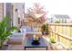Inviting outdoor deck with comfortable seating area, wooden flooring, and privacy fence at 8951 E 59Th Pl, Denver, CO 80238