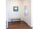 Clean and bright entryway with hardwood floors, a bench, and a glass-paneled front door at 8951 E 59Th Pl, Denver, CO 80238