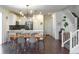 Open-concept kitchen and dining area with modern lighting, white cabinetry, and stainless steel appliances at 8951 E 59Th Pl, Denver, CO 80238