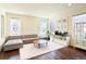 Sunlit living room featuring hardwood floors, sectional sofa, and a view of the neighborhood at 8951 E 59Th Pl, Denver, CO 80238