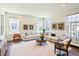 Bright living room with hardwood floors, neutral furniture, and natural light from multiple windows at 8951 E 59Th Pl, Denver, CO 80238