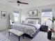 Beautifully staged bedroom with a large bed, stylish mirror, and plenty of natural light at 8951 E 59Th Pl, Denver, CO 80238