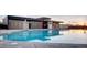 Outdoor community swimming pool with modern architecture and clean, clear water reflecting sunset at 8951 E 59Th Pl, Denver, CO 80238