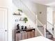 Staircase with minimalist decor, wooden accents, and adjacent coffee station at 8951 E 59Th Pl, Denver, CO 80238