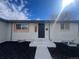 Charming home entrance with a freshly painted door, modern exterior lighting, and clean landscaping at 7956 Joan Dr, Denver, CO 80221