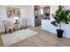 Bright and airy living room with modern flooring, art, and a view of the kitchen at 7956 Joan Dr, Denver, CO 80221