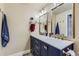 Bathroom with a double vanity, updated hardware, and navy blue cabinets at 7261 E Hinsdale Ave, Centennial, CO 80112