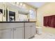 Clean bathroom with double sinks, light grey cabinets, and updated fixtures at 7261 E Hinsdale Ave, Centennial, CO 80112