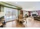 Kitchen dining area with wood floors and sliding glass door to backyard at 7261 E Hinsdale Ave, Centennial, CO 80112