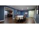 Traditional dining room with dark wood floors, blue accent wall, and seating for six at 7261 E Hinsdale Ave, Centennial, CO 80112