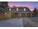 Two-story house with a brown exterior, two-car garage, and solar panels on the roof at 7261 E Hinsdale Ave, Centennial, CO 80112