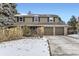 Two-story house with a brown exterior, two-car garage, and solar panels on the roof at 7261 E Hinsdale Ave, Centennial, CO 80112