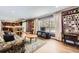 Living room with hardwood floors, fireplace, and large windows at 7261 E Hinsdale Ave, Centennial, CO 80112