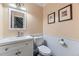 Powder room with a pedestal sink, toilet, and neutral color palette at 7261 E Hinsdale Ave, Centennial, CO 80112