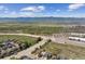 An aerial view displaying homes and a picturesque landscape with mountains and a highway at 3787 Bucknell Dr, Highlands Ranch, CO 80129