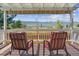 Covered deck showcasing picturesque mountain views and comfortable seating at 3787 Bucknell Dr, Highlands Ranch, CO 80129