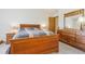Bedroom features a wooden bed frame, matching nightstands, and a large dresser with mirror at 3787 Bucknell Dr, Highlands Ranch, CO 80129