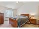 Bedroom with vaulted ceilings featuring a wooden bed frame, nightstands, and large windows at 3787 Bucknell Dr, Highlands Ranch, CO 80129