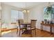 Bright dining room with hardwood floors, large windows, and a stylish chandelier at 3787 Bucknell Dr, Highlands Ranch, CO 80129