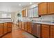 Well-lit kitchen featuring stainless steel appliances, wooden cabinets, and modern fixtures at 3787 Bucknell Dr, Highlands Ranch, CO 80129
