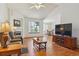 Open-concept living room with hardwood floors, fireplace, and abundant natural light at 3787 Bucknell Dr, Highlands Ranch, CO 80129