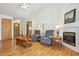 Inviting living room featuring hardwood floors, a cozy fireplace, and vaulted ceilings at 3787 Bucknell Dr, Highlands Ranch, CO 80129