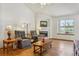 Comfortable living room featuring a cozy fireplace and a view of the backyard at 3787 Bucknell Dr, Highlands Ranch, CO 80129