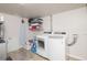 Laundry room with washer, dryer, and storage shelves at 1059 S Alkire St, Lakewood, CO 80228