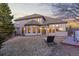 Expansive backyard showcasing the home's exterior, patio, and surrounding greenery at 5810 Amber Ridge Dr, Castle Pines, CO 80108