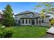 Expansive backyard with lush lawn, manicured landscaping, and elegant exterior of the home at 5810 Amber Ridge Dr, Castle Pines, CO 80108