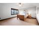 Bedroom with large window, ceiling fan, and neutral carpeting, offering comfort and style at 5810 Amber Ridge Dr, Castle Pines, CO 80108