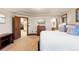 Bright bedroom showcasing a comfortable bed, dresser, and doorway views of other home features at 5810 Amber Ridge Dr, Castle Pines, CO 80108