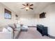 Upstairs bonus room with TV, comfortable seating, and a ceiling fan at 5810 Amber Ridge Dr, Castle Pines, CO 80108