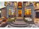 Stunning stone-clad home featuring an arched entryway and elegant architectural details at 5810 Amber Ridge Dr, Castle Pines, CO 80108