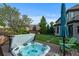 Relaxing backyard hot tub with wooden deck and patio furniture, perfect for enjoying the outdoors at 5810 Amber Ridge Dr, Castle Pines, CO 80108