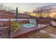 Outdoor hot tub on a wooden deck, complemented by lounge chairs and a serene setting at 5810 Amber Ridge Dr, Castle Pines, CO 80108