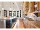 Gourmet kitchen with a large island, stone countertops, custom cabinets, and stainless steel appliances at 5810 Amber Ridge Dr, Castle Pines, CO 80108